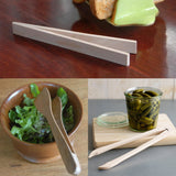 Set of wooden tongs used for various purposes including salad, pickles, and bread.