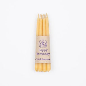 11 thin beeswax birthday candles light up a chocolate birthday cake